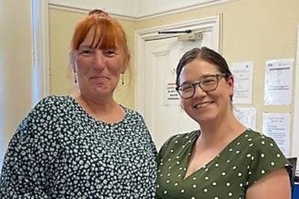 Photo of Jane receiving jewellery from Patient Services manager Alice