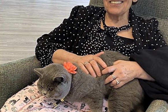 Baby the cat with one of the residents